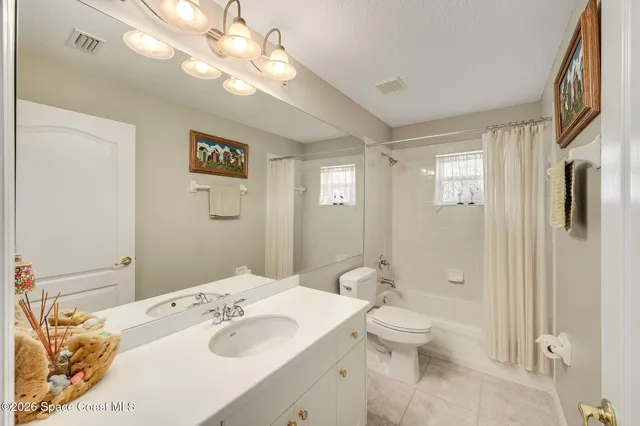 a living room with couches and a bookshelf