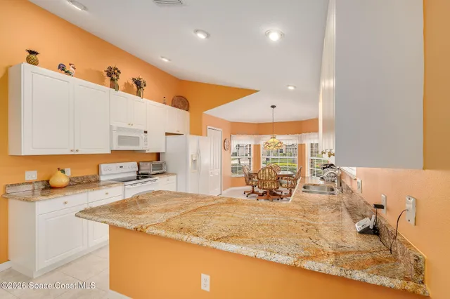 a dining room with furniture and chandelier