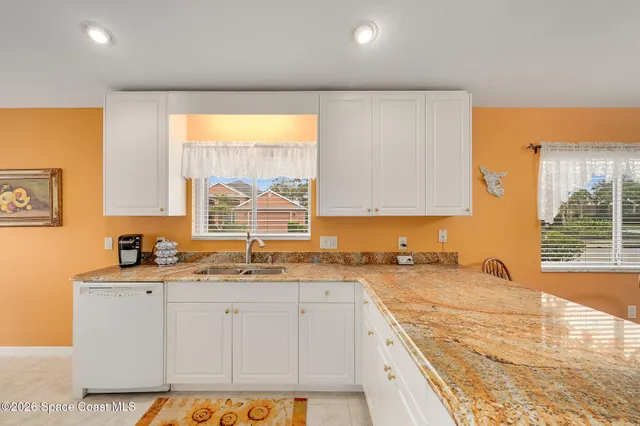 a dining room with furniture a chandelier and window