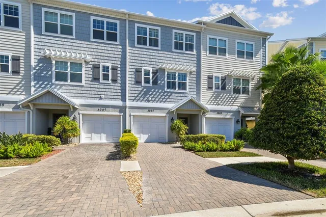 a kitchen with stainless steel appliances granite countertop a sink a stove a microwave and wooden cabinets