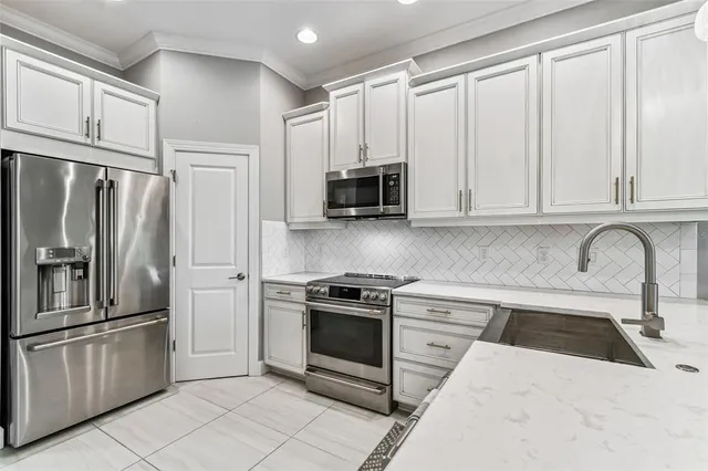 a spacious bedroom with a large bed and a flat screen tv