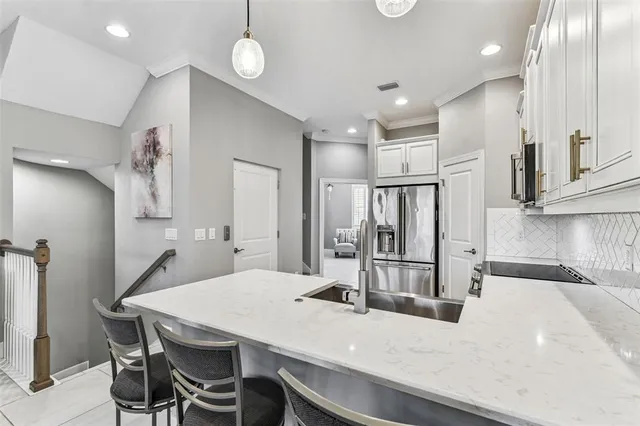 a bedroom with a bed and a flat tv screen on the dresser