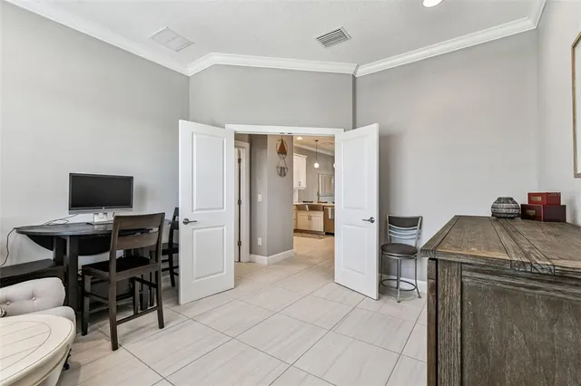 a view of a livingroom with workspace and a flat screen tv