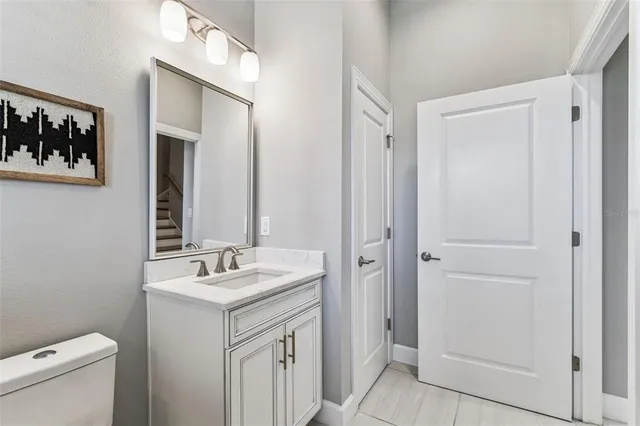 a view of a building with a yard and potted plants