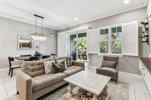 a living room with furniture a large window and a flat screen tv