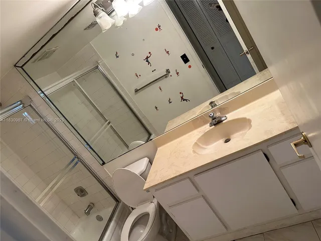 a kitchen with stainless steel appliances granite countertop a sink a stove and white cabinets