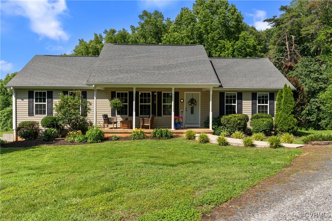 a front view of a house with sitting area and garden