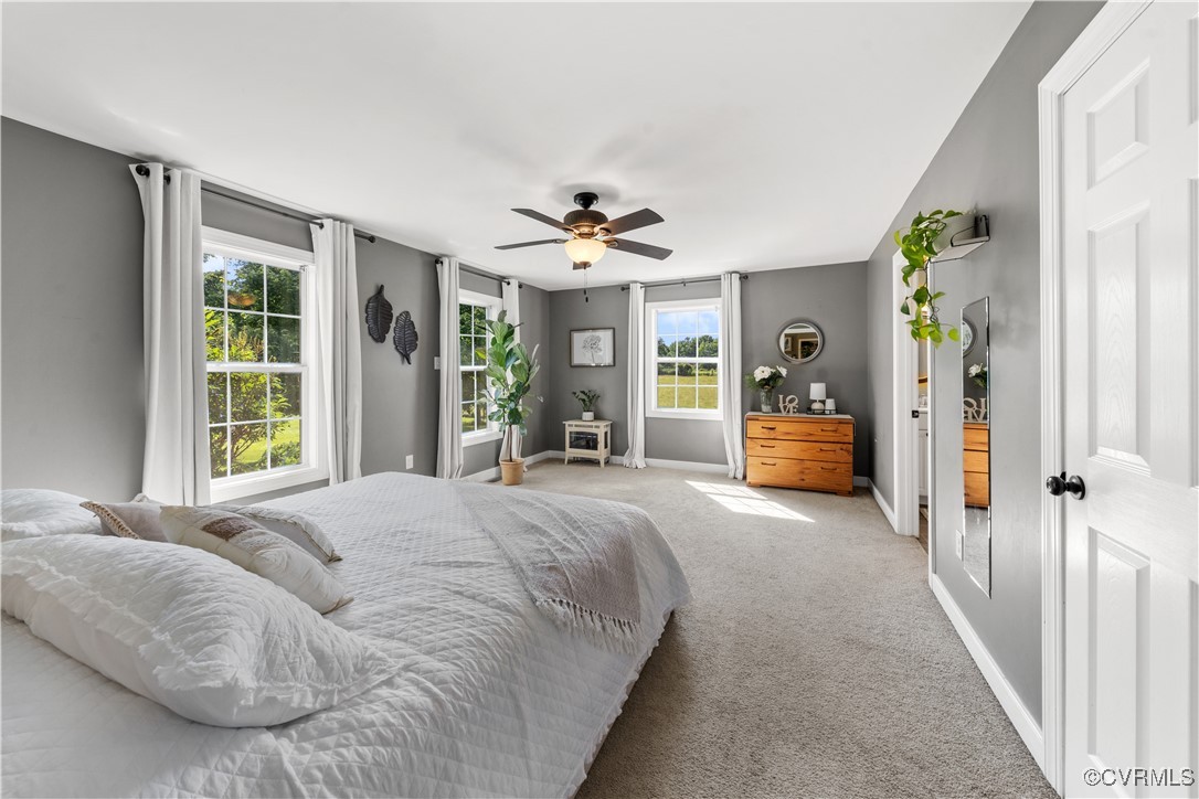 201 School Road Dillwyn, VA 23936 - Photo 22 of 48 a spacious bedroom with a large bed and a chandelier
