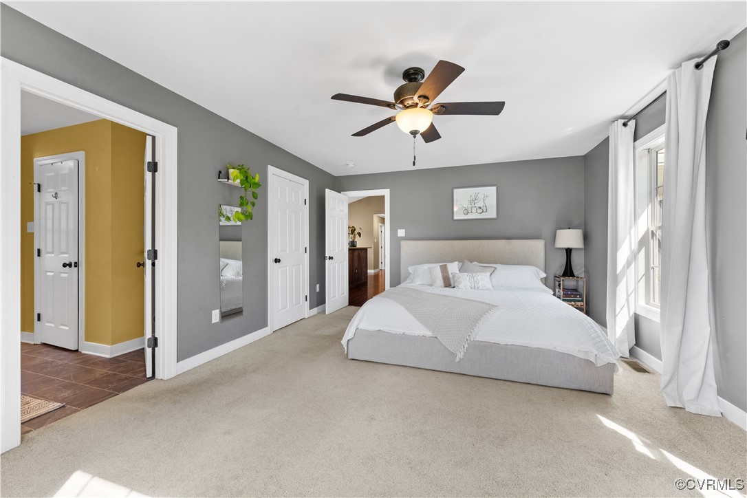 201 School Road Dillwyn, VA 23936 - Photo 23 of 48 a spacious bedroom with a large bed and a chandelier