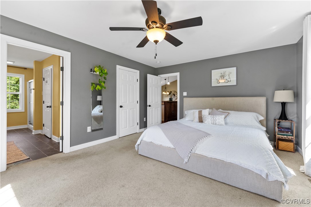 201 School Road Dillwyn, VA 23936 - Photo 24 of 48 a spacious bedroom with a bed and a chandelier