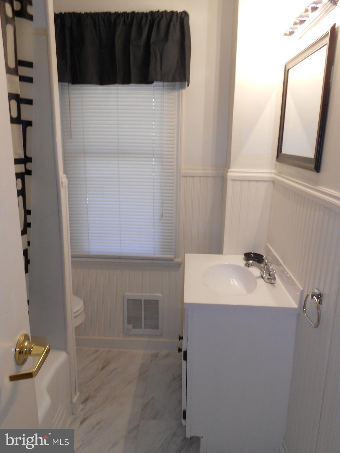8224 Oakleigh Road Baltimore, MD 21234 - Photo 14 of 26 a bathroom with a sink and a mirror