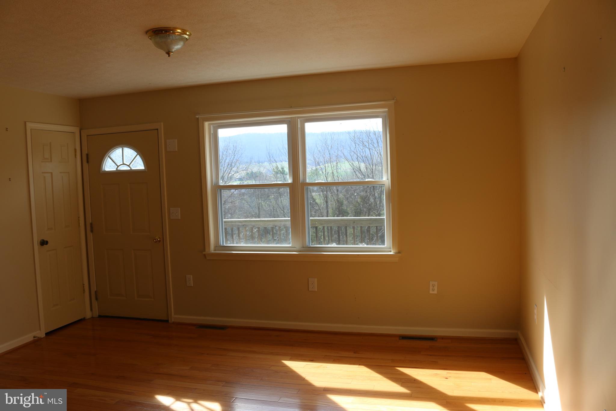 156 Squirrel Den Road Maysville, WV 26833 - Photo 17 of 41 an empty room with windows