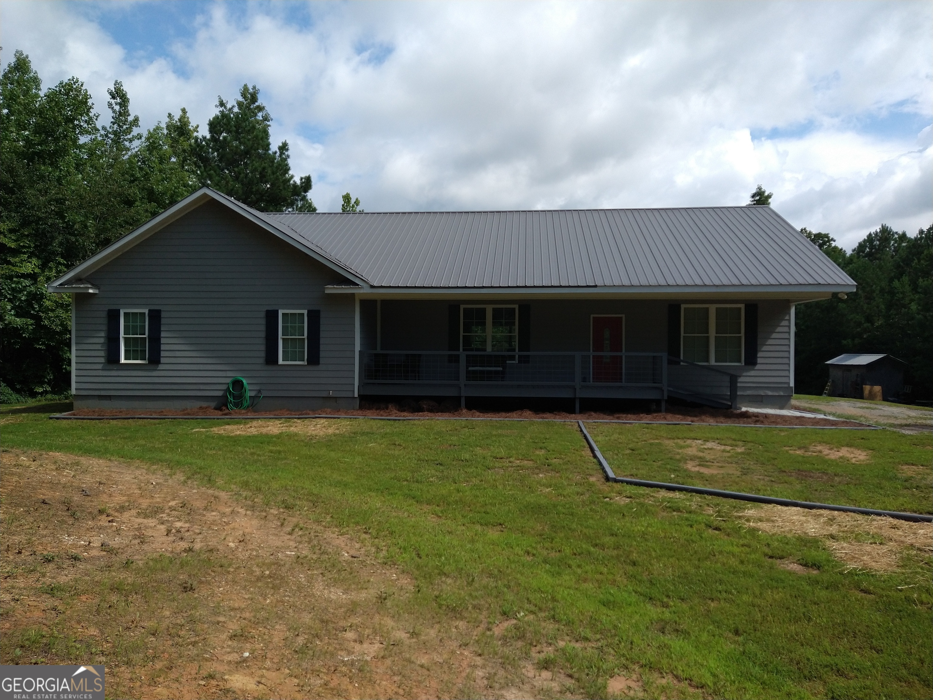 2704 Cross Roads Church Road Buchanan, GA 30113 - Photo 1 of 1 a front view of a house with a garden