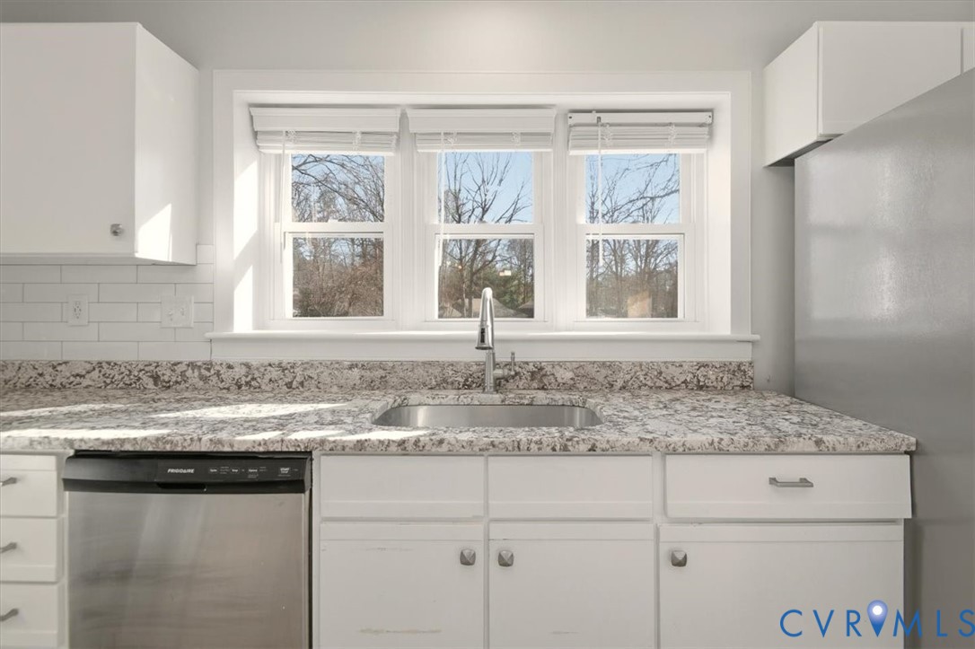 5600 Woods Walk Road Midlothian, VA 23112 - Photo 16 of 44 a kitchen with granite countertop sink and window