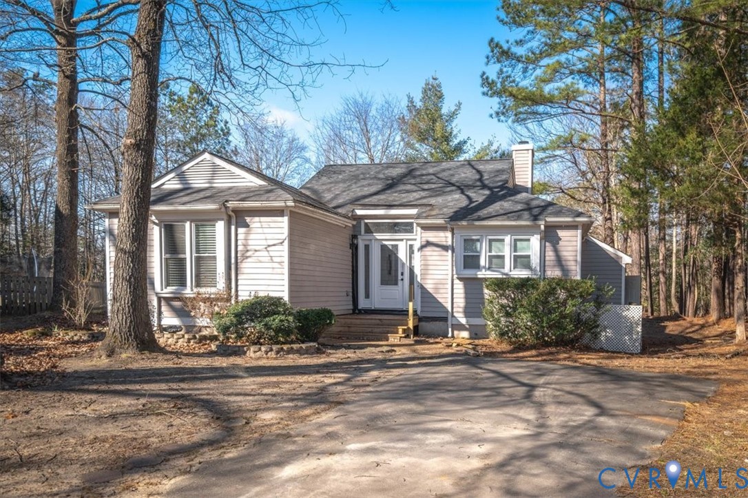 5600 Woods Walk Road Midlothian, VA 23112 - Photo 2 of 44 a front view of a house with a yard and potted plants