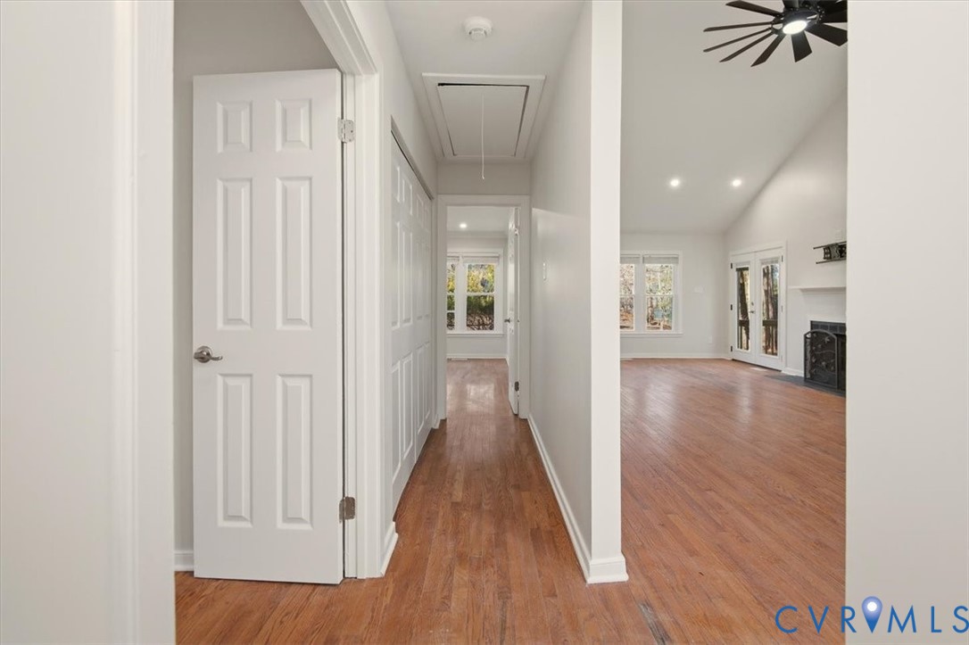 5600 Woods Walk Road Midlothian, VA 23112 - Photo 23 of 44 a view of a hallway with wooden floor windows and a living room