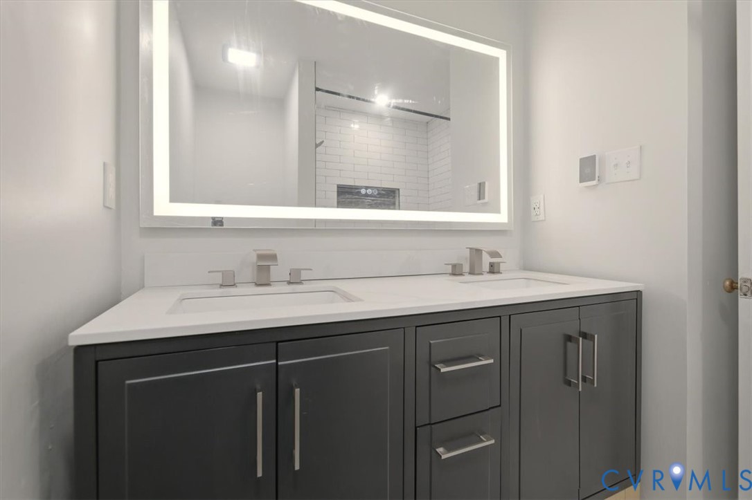 5600 Woods Walk Road Midlothian, VA 23112 - Photo 26 of 44 a bathroom with a sink and a mirror