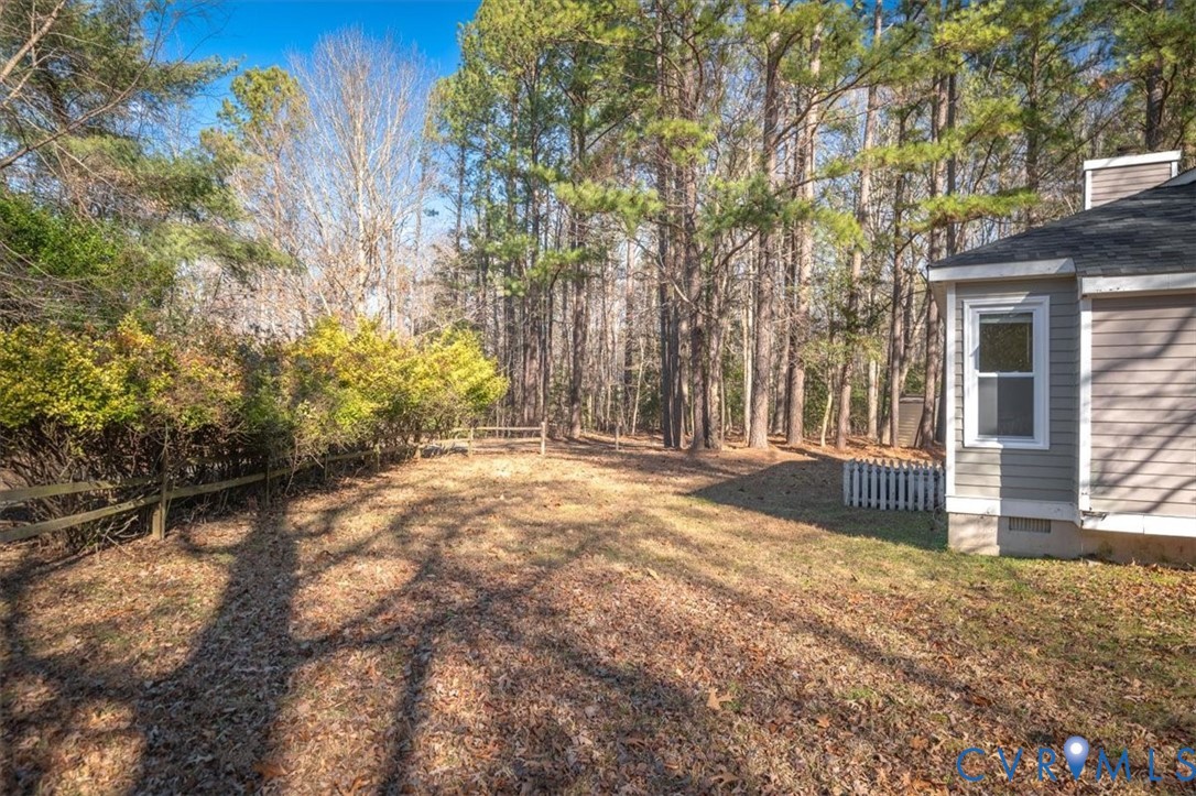 5600 Woods Walk Road Midlothian, VA 23112 - Photo 44 of 44 a view of a yard with plants and trees