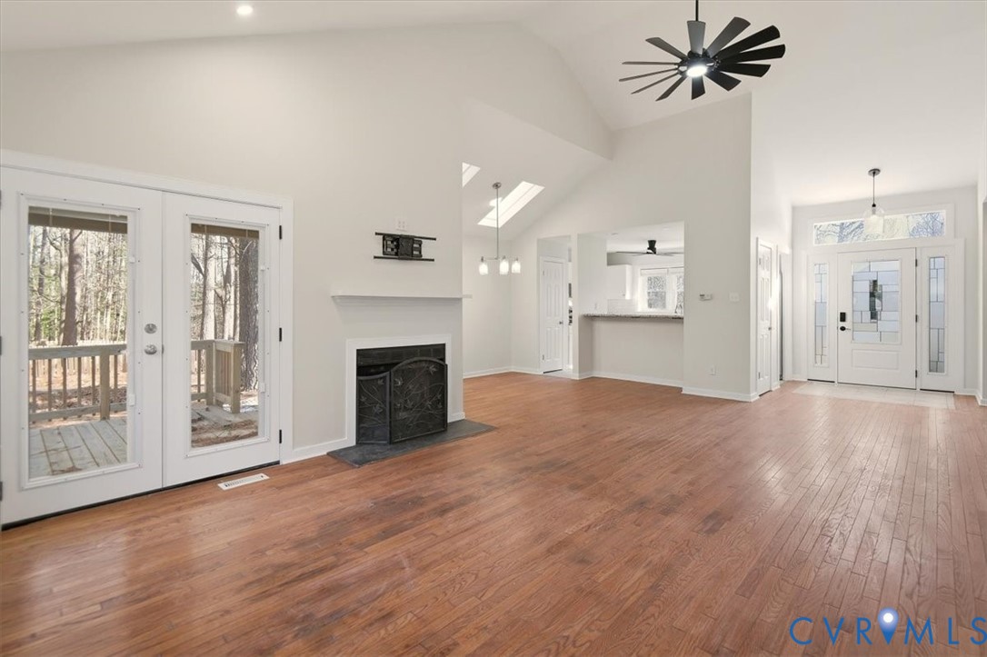 5600 Woods Walk Road Midlothian, VA 23112 - Photo 10 of 44 a view of a livingroom with a fireplace a ceiling fan and windows