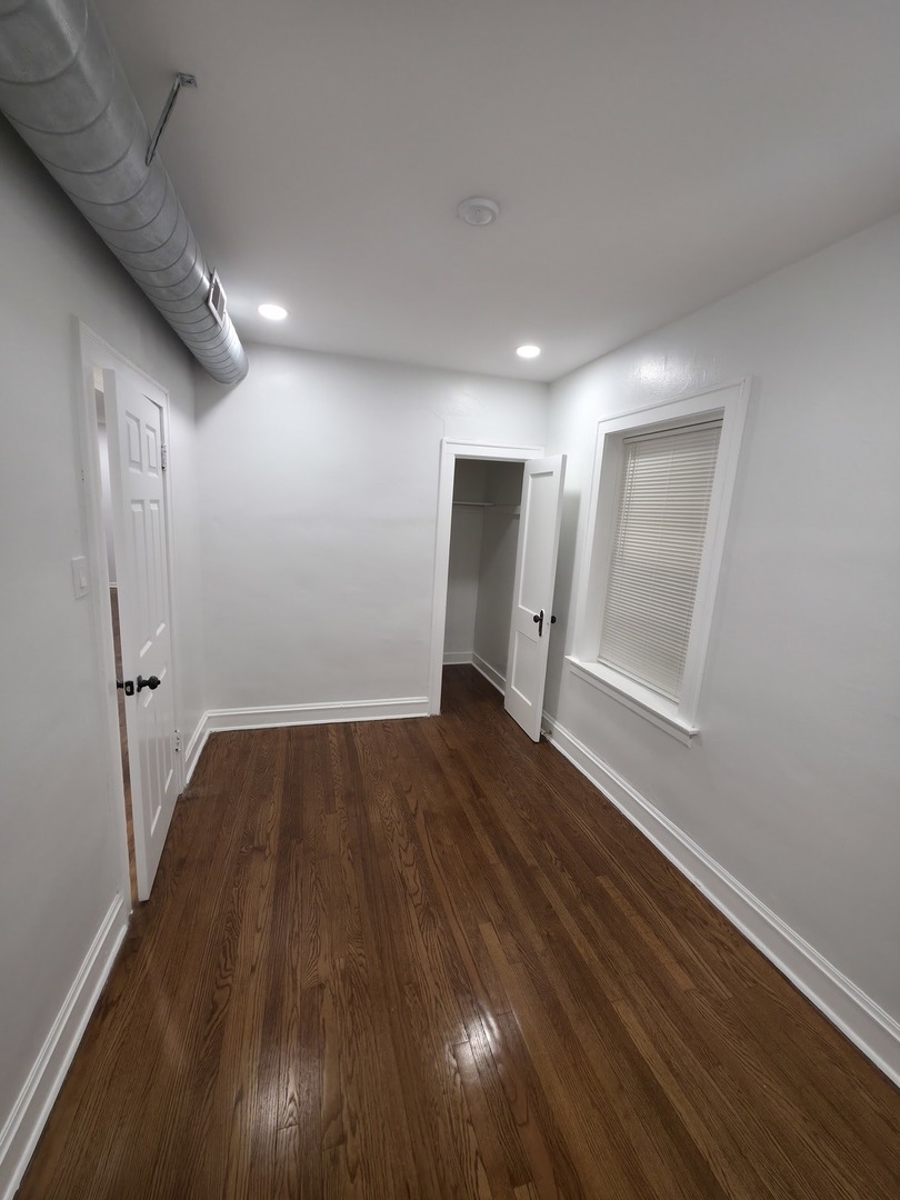 1748 North Keystone Avenue Chicago, IL 60639 - Photo 16 of 33 a view of a room with wooden floor and window