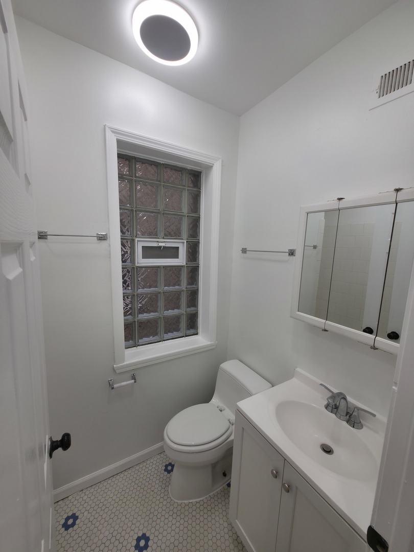 1748 North Keystone Avenue Chicago, IL 60639 - Photo 17 of 33 a bathroom with a sink a toilet and shower