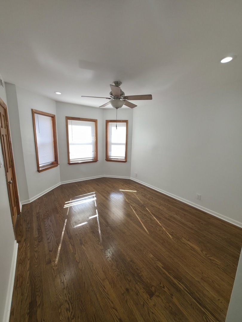 1748 North Keystone Avenue Chicago, IL 60639 - Photo 19 of 33 wooden floor in an empty room with a window