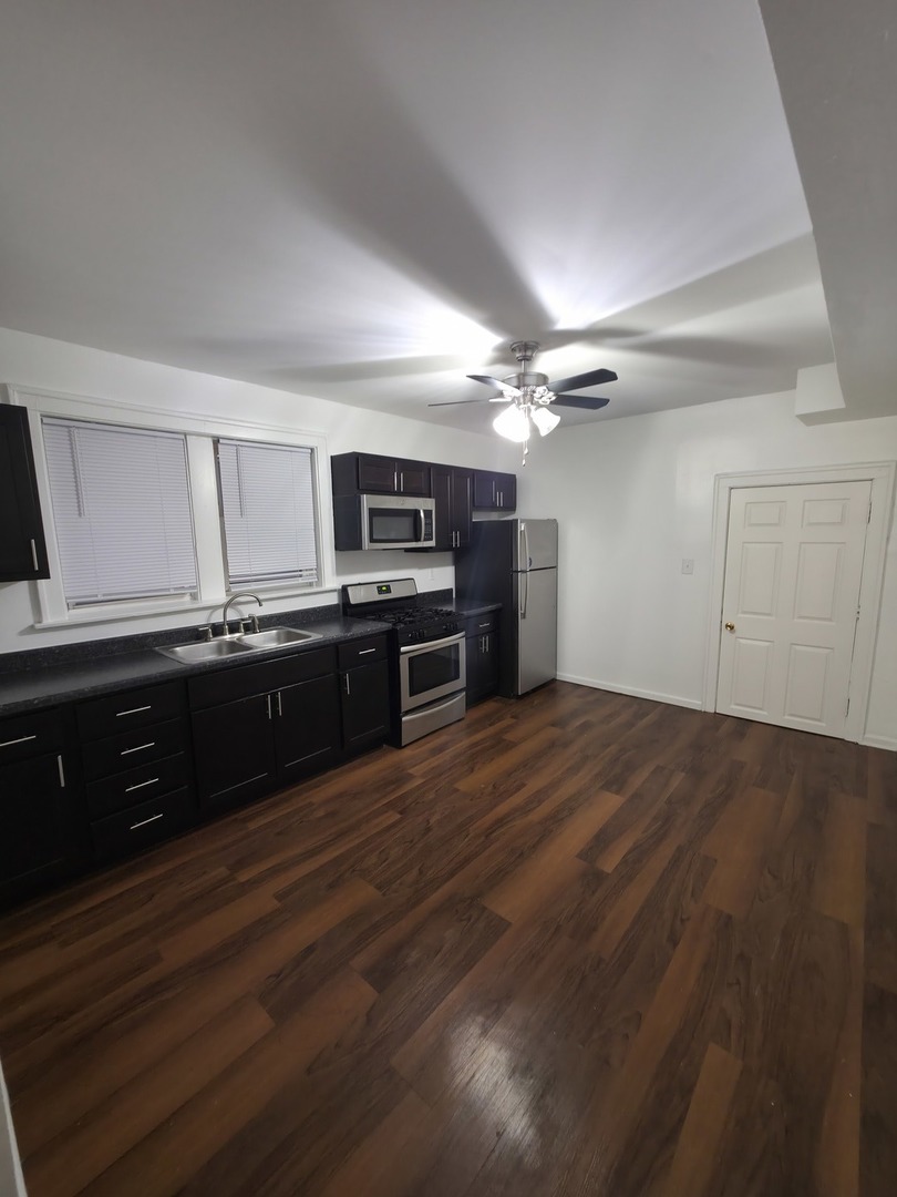 1748 North Keystone Avenue Chicago, IL 60639 - Photo 22 of 33 a kitchen with stainless steel appliances a sink and cabinets