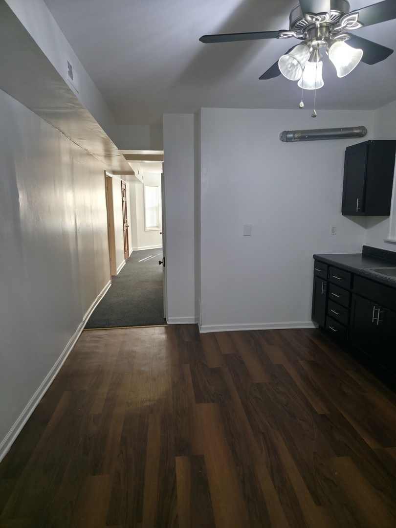 1748 North Keystone Avenue Chicago, IL 60639 - Photo 24 of 33 en empty room with wooden floor fan and window