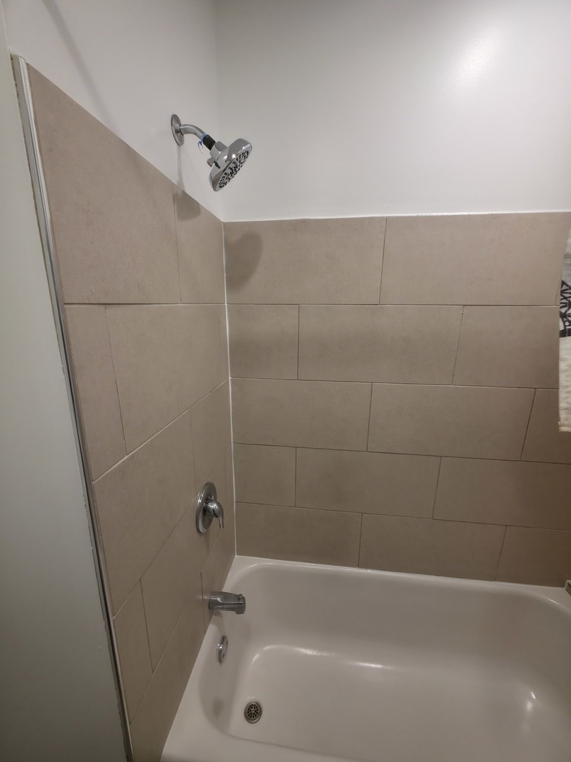 1748 North Keystone Avenue Chicago, IL 60639 - Photo 26 of 33 a bathroom with a tub and a shower