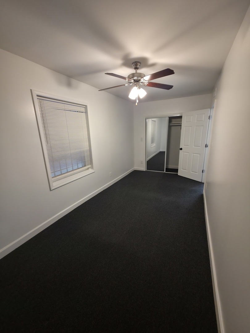 1748 North Keystone Avenue Chicago, IL 60639 - Photo 27 of 33 a view of an empty room with a ceiling fan and a window