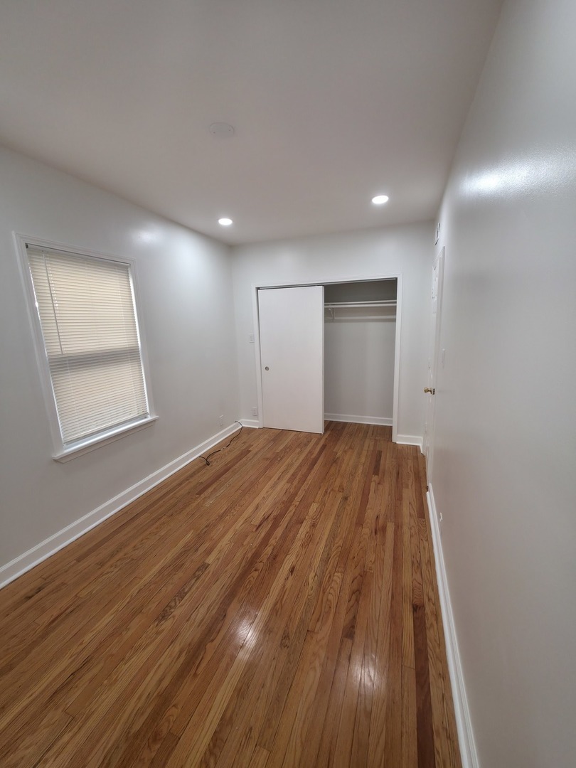 1748 North Keystone Avenue Chicago, IL 60639 - Photo 4 of 33 a view of empty room with wooden floor