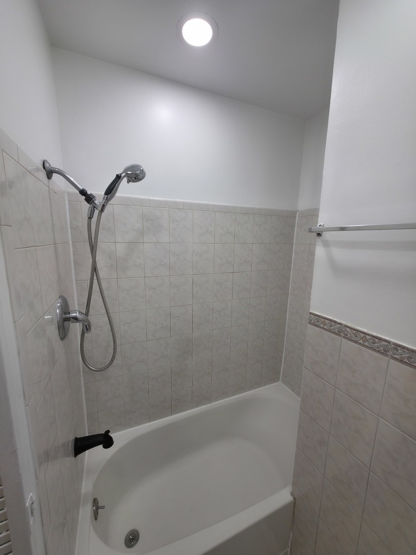 1748 North Keystone Avenue Chicago, IL 60639 - Photo 7 of 33 a bathroom with a bath tub and a shower