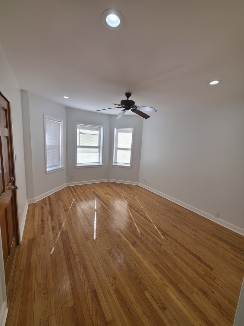 1748 North Keystone Avenue Chicago, IL 60639 - Photo 8 of 33 a view of empty room with wooden floor and fan