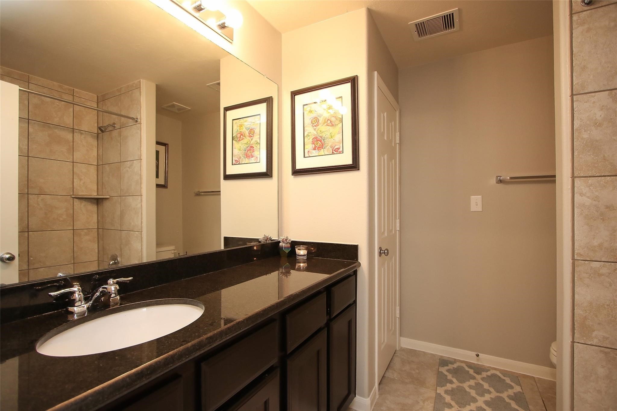8517 Sunset Loch Drive Spring, TX 77379 - Photo 18 of 22 a bathroom with a sink and a mirror