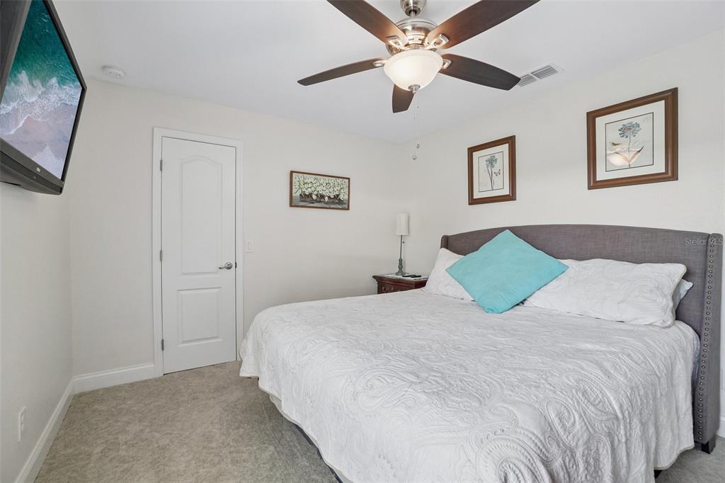 3934 Connersville Road Bartow, FL 33830 - Photo 52 of 81 a bedroom with a large bed and a chandelier