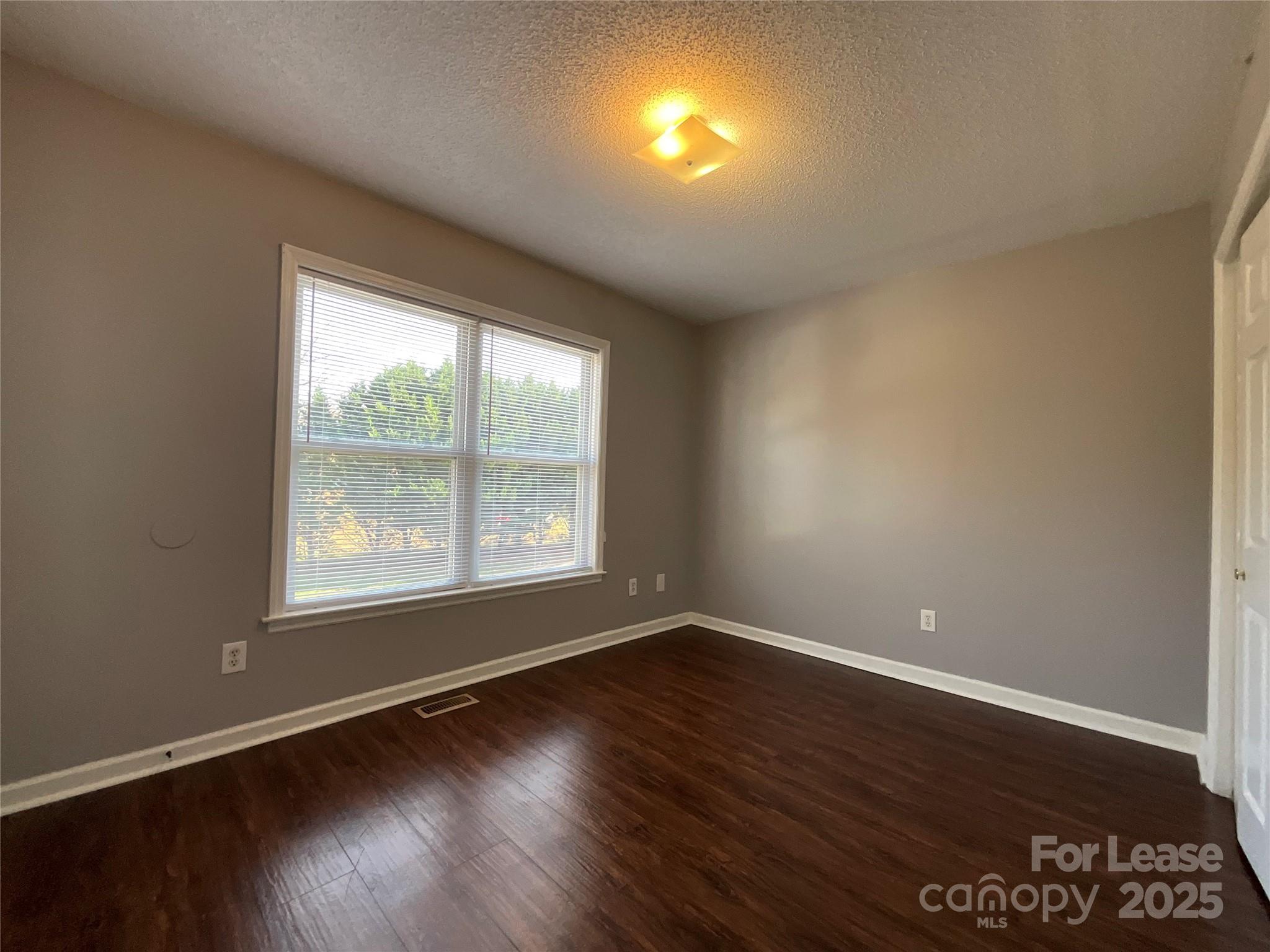 206 West 15th Street, Unit 3 Newton, NC 28658 - Photo 11 of 13 an empty room with wooden floor and windows