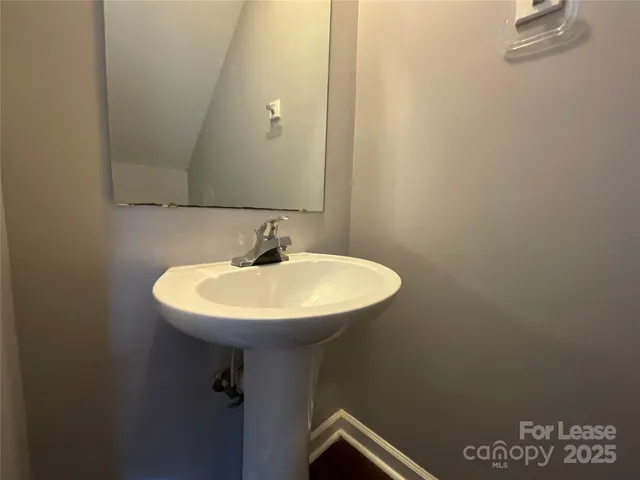 a bathroom with a sink a mirror and a sink