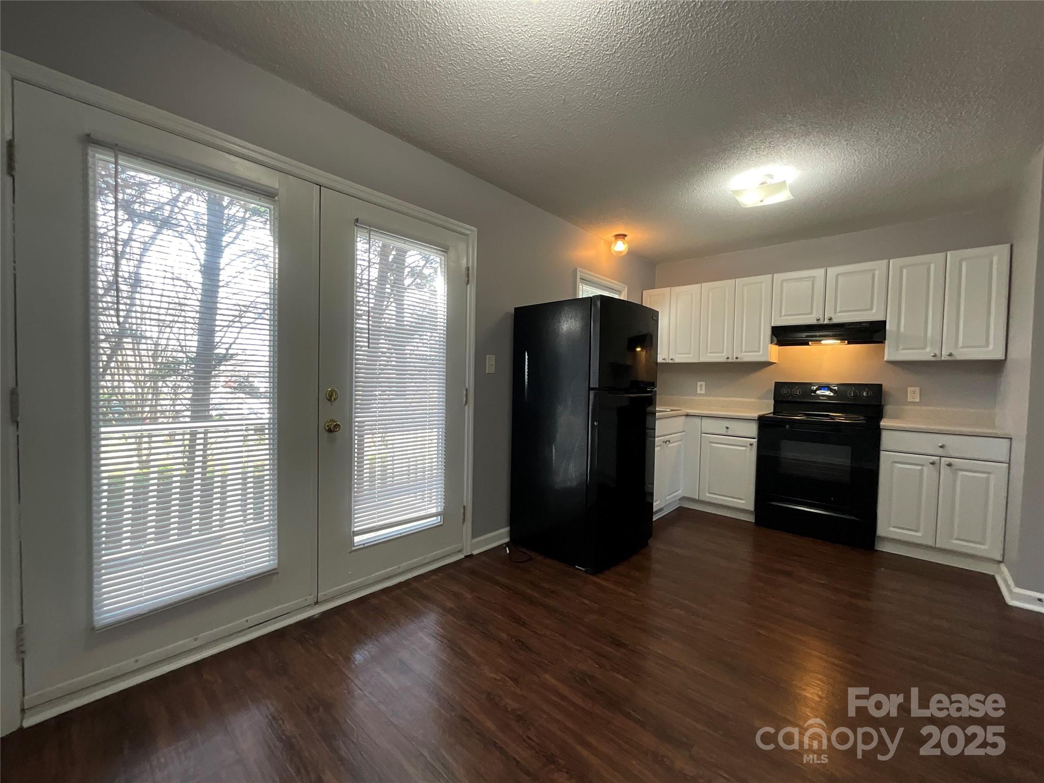 206 West 15th Street, Unit 3 Newton, NC 28658 - Photo 7 of 13 a kitchen with stainless steel appliances granite countertop a refrigerator a sink a stove a microwave and wooden floor
