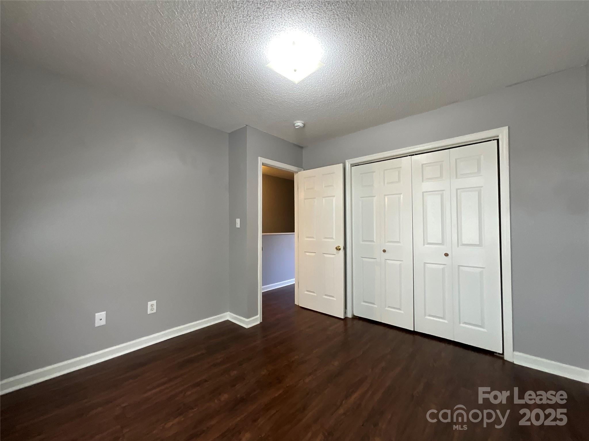 206 West 15th Street, Unit 3 Newton, NC 28658 - Photo 10 of 13 a view of an empty room with wooden floor and closet