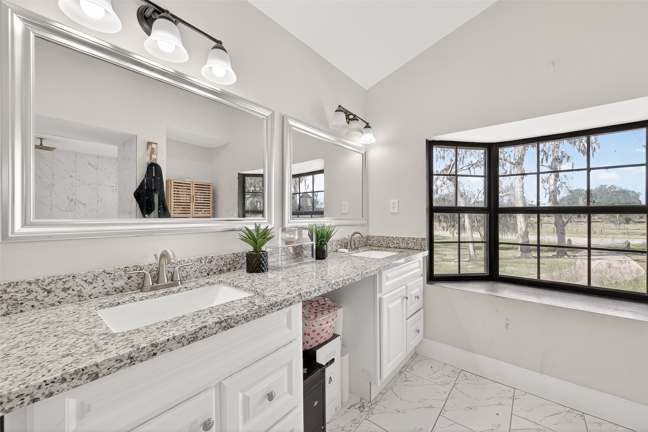 29927 County Road 25 Damon, TX 77430 - Photo 16 of 43 a spacious bathroom with a granite countertop double vanity sink a mirror and a bathtub