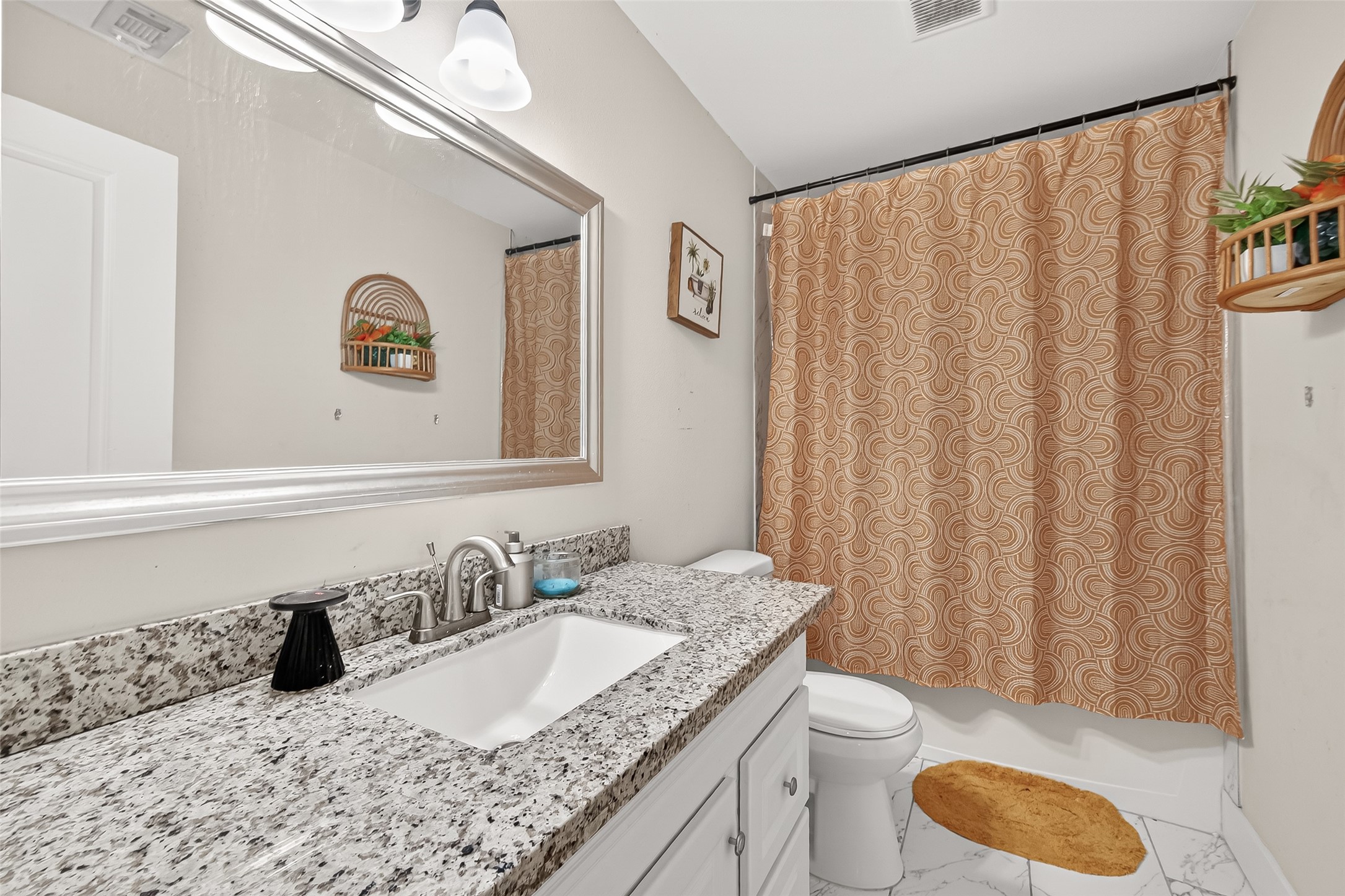 29927 County Road 25 Damon, TX 77430 - Photo 20 of 43 a bathroom with a granite countertop sink vanity mirror and toilet