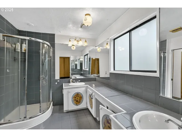 a bathroom with a sink a mirror and a bath tub