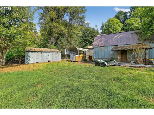 a backyard of a house with table and chairs