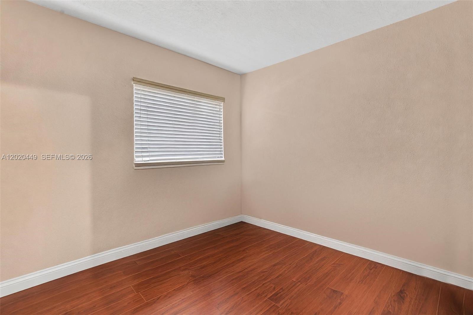 11061 Southwest 163rd Street Miami, FL 33157 - Photo 16 of 42 a view of an empty room with wooden floor and a window
