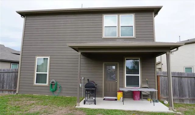 a backyard of a house with plants and garden