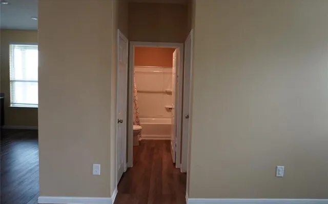 a view of a bathroom from a hallway