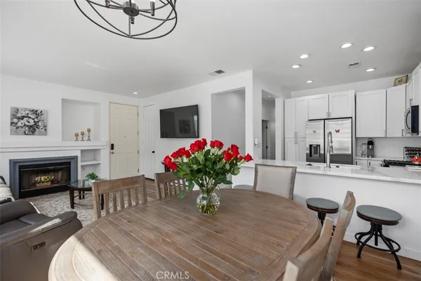 a dining room with furniture a fireplace and chandelier