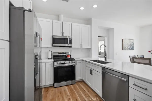 a kitchen with a sink stove and refrigerator