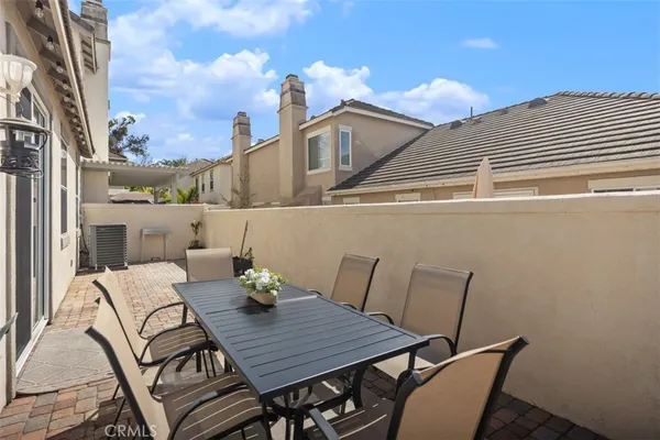 a view of a patio with table and chairs