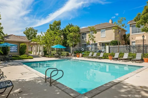 a view of a swimming pool with outdoor seating and a patio